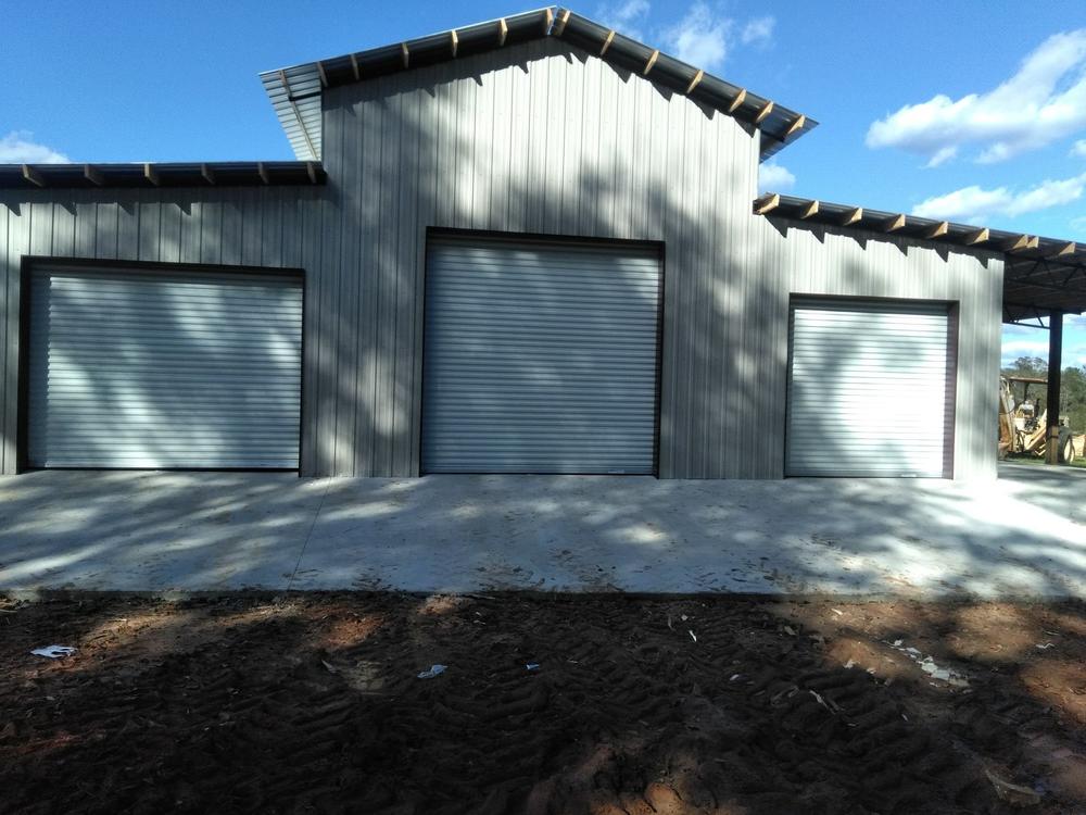 Metal pole barn with roll-up doors in Navarre, FL